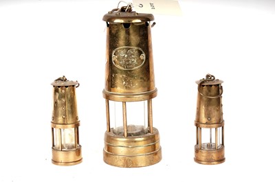 Lot 88 - Three brass miners safety lamps