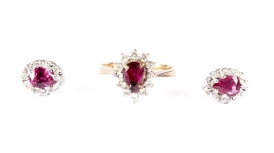 Lot 1222 - A ruby and diamond cluster ring and matching earrings