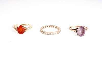 Lot 375 - A fire opal and diamond ring; and two others