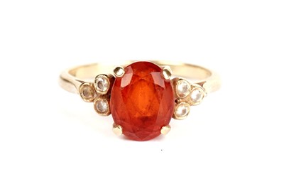 Lot 375 - A fire opal and diamond ring; and two others