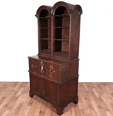 Lot 69 - A Georgian style oak double dome bookcase cabinet