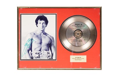 Lot 939 - A Rocky IV 'gold' disc and signed Sylvester Stallone photograph