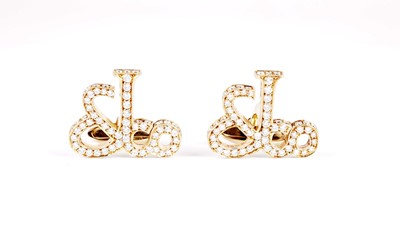 Lot 1134 - Jacob & Co, New York: a pair of diamond-set yellow gold monogram pattern cufflinks