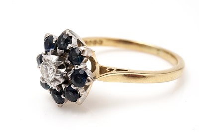 Lot 426 - A diamond and sapphire cluster ring