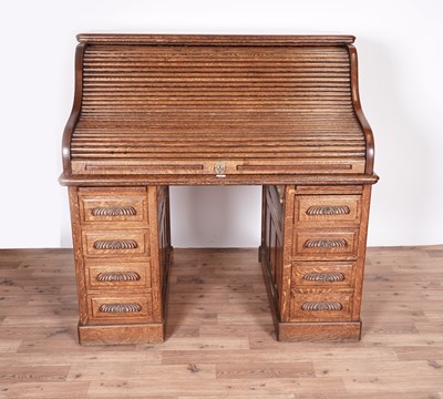 Lot 30 - An early 20th Century oak roll-top desk