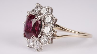 Lot 1076 - A ruby and diamond cluster ring