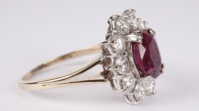 Lot 1076 - A ruby and diamond cluster ring