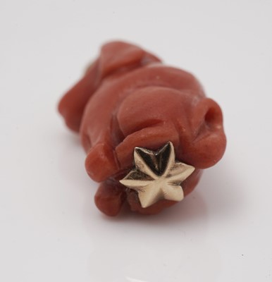 Lot 417 - A carved coral dog pattern pendant