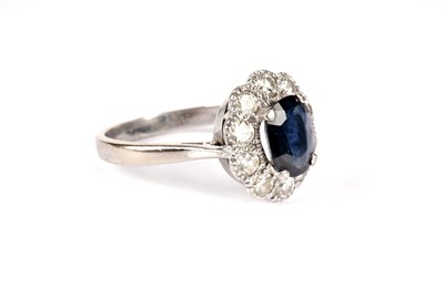 Lot 1080 - A sapphire and diamond cluster ring