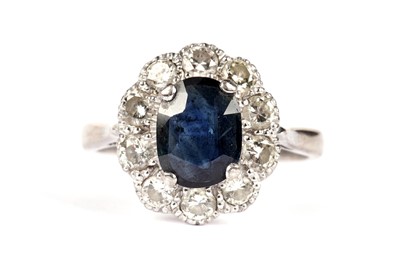 Lot 1080 - A sapphire and diamond cluster ring