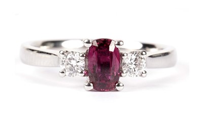 Lot 1290 - A three stone ruby and diamond ring
