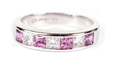 Lot 1293 - A pink sapphire and diamond half-hoop eternity ring