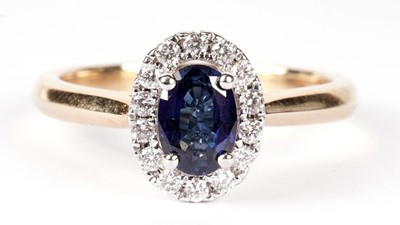 Lot 1296 - A sapphire and diamond cluster ring