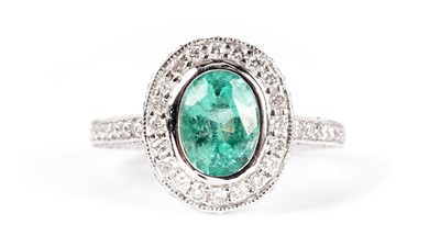 Lot 1302 - An emerald and diamond cluster ring