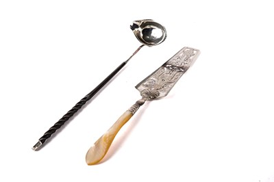Lot 506 - A German silver tartlet slice and a Georgian silver toddy ladle
