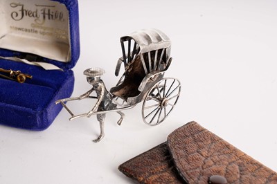 Lot 516 - A Chinese silver rickshaw and driver, and other items