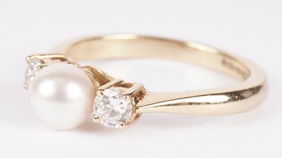 Lot 1081 - A cultured pearl and diamond ring