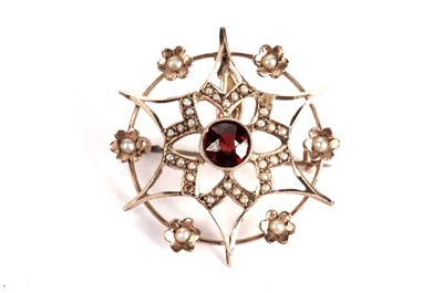 Lot 337 - An Edwardian garnet and seed pearl flower pendant brooch