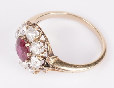 Lot 1153 - A ruby and diamond cluster ring
