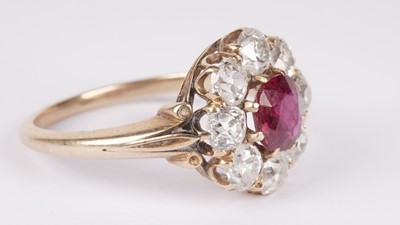 Lot 1153 - A ruby and diamond cluster ring