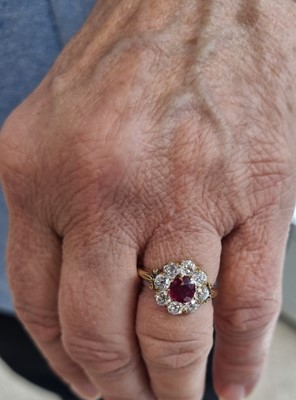 Lot 1153 - A ruby and diamond cluster ring