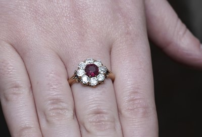 Lot 1153 - A ruby and diamond cluster ring