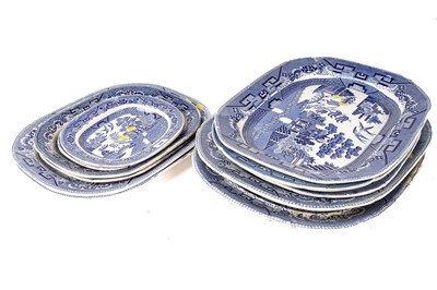 Lot 300 - A set of eleven ‘Willow’ pattern graduated meat and serving plates