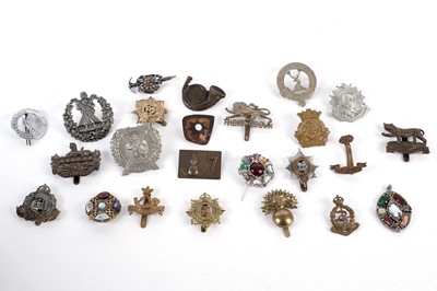 Lot 496 - A collection of military cap badges and brooches