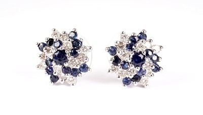 Lot 1206 - A pair of sapphire and diamond cluster earrings