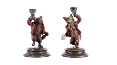 Lot 683 - A pair of cold painted bronze candlesticks