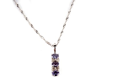 Lot 374 - A tanzanite and diamond pendant on chain