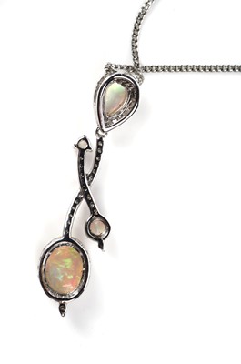 Lot 1141 - An opal and diamond pendant