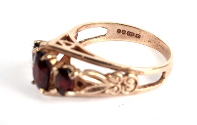 Lot 345 - A garnet ring and two other rings