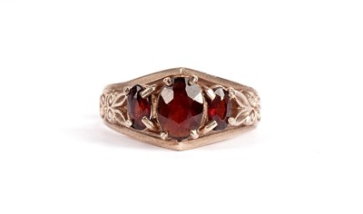 Lot 345 - A garnet ring and two other rings