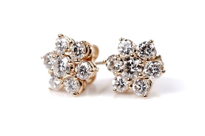 Lot 1157 - A pair of diamond cluster earrings