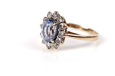 Lot 1158 - A sapphire and diamond cluster ring