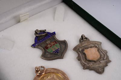 Lot 427 - Two 1920s football medals; and another silver sporting medal