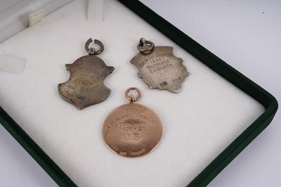 Lot 427 - Two 1920s football medals; and another silver sporting medal