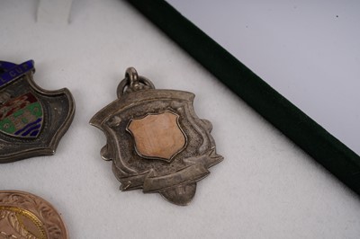 Lot 427 - Two 1920s football medals; and another silver sporting medal