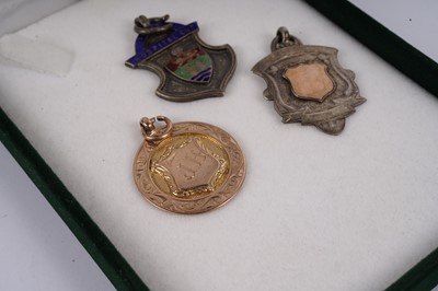 Lot 427 - Two 1920s football medals; and another silver sporting medal
