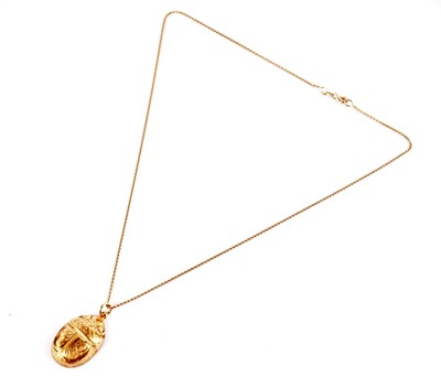 Lot 459 - A yellow gold scarab pendant on chain