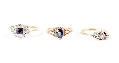 Lot 462 - A sapphire and diamond ring; and two others