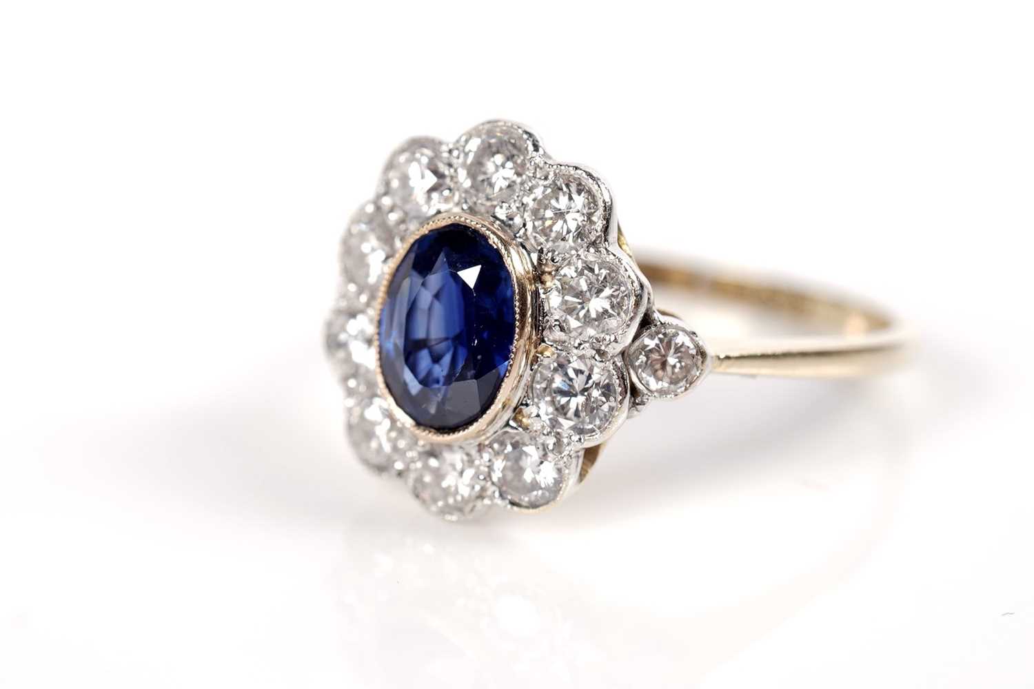 Lot 1164 - A sapphire and diamond cluster ring