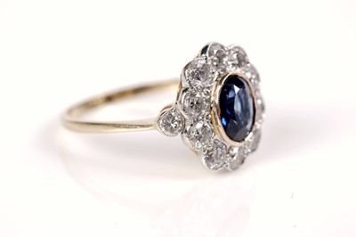 Lot 1164 - A sapphire and diamond cluster ring