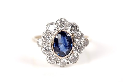 Lot 1164 - A sapphire and diamond cluster ring