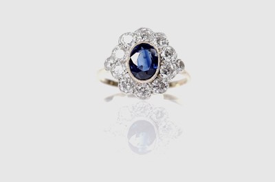 Lot 1164 - A sapphire and diamond cluster ring