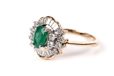 Lot 1165 - An emerald and diamond cluster ring