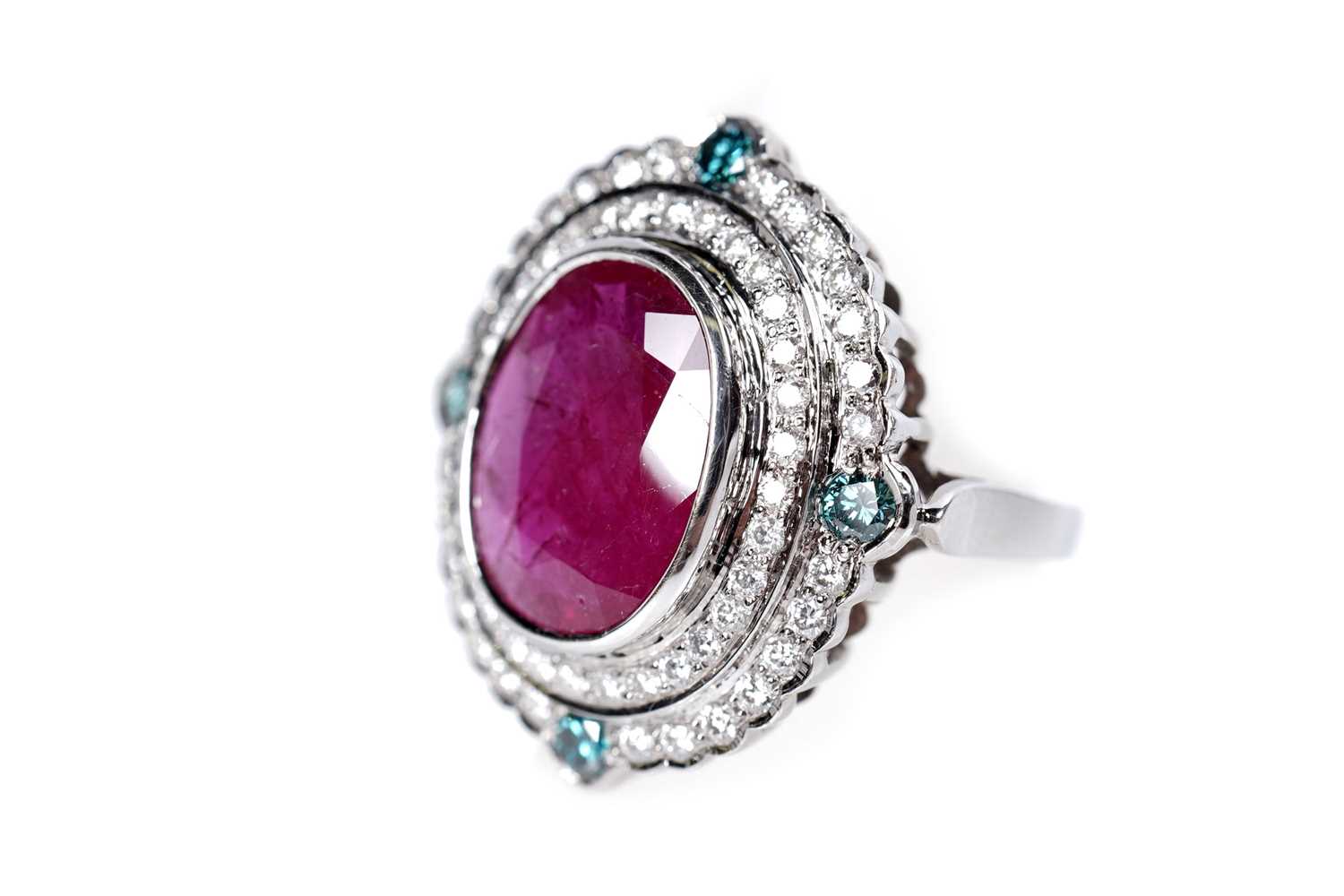 Lot 1166 - A ruby, blue diamond, and diamond dress ring