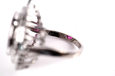 Lot 1166 - A ruby, blue diamond, and diamond dress ring