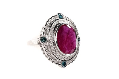 Lot 1166 - A ruby, blue diamond, and diamond dress ring